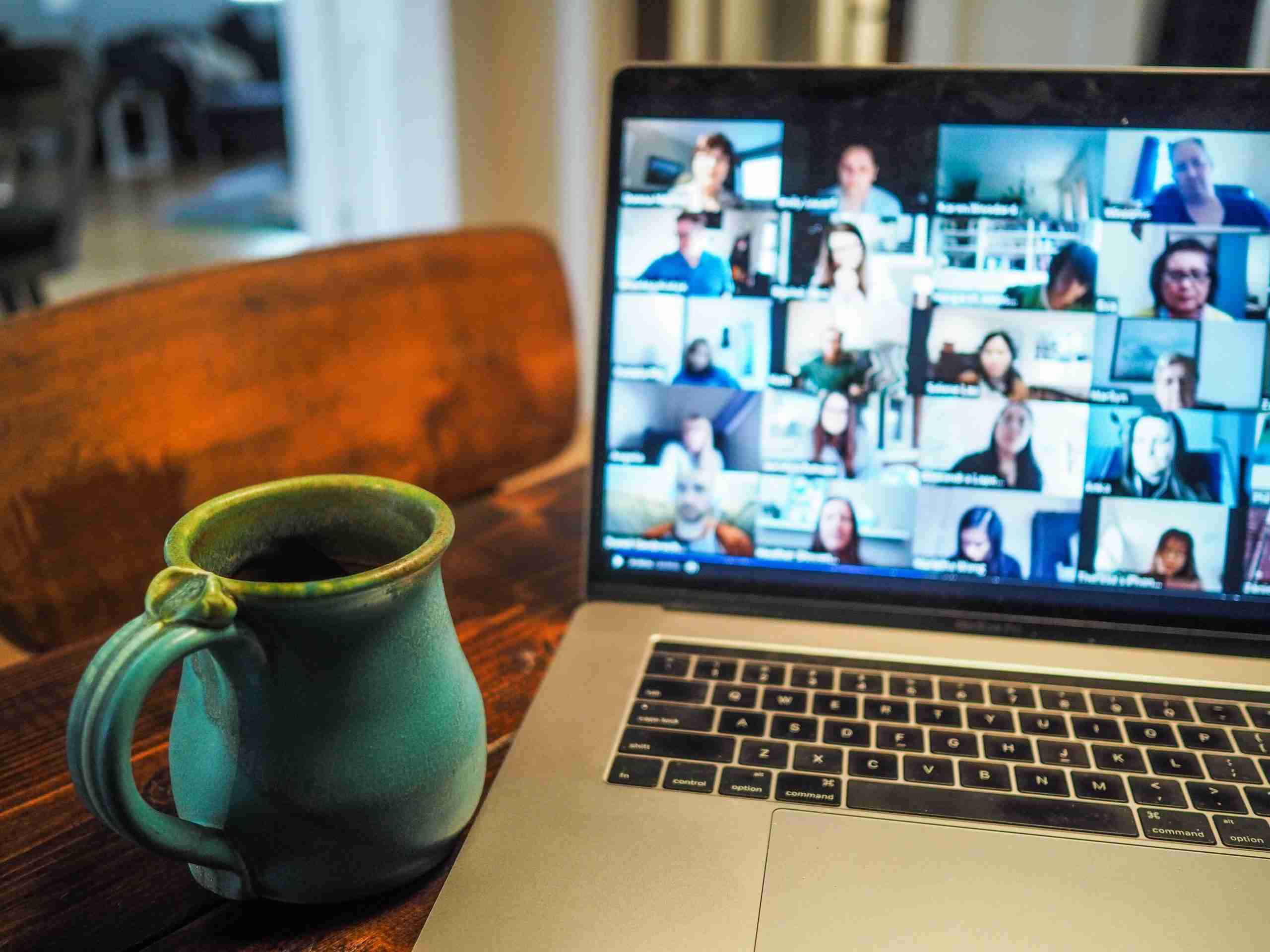 Laptop with a Zoom call in progress, and a cuppa